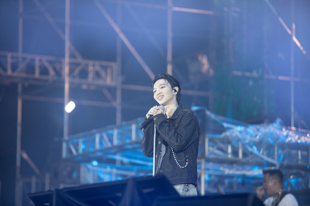 A man standing on top of a stage holding a microphone