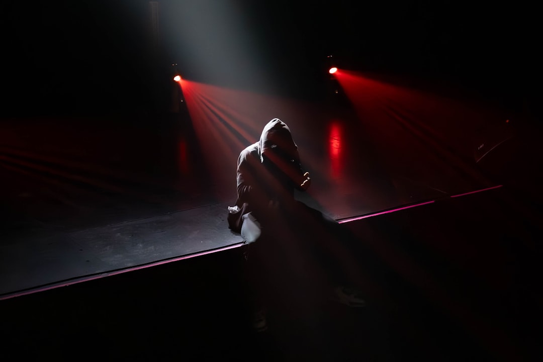 A person standing on a stage with a microphone
