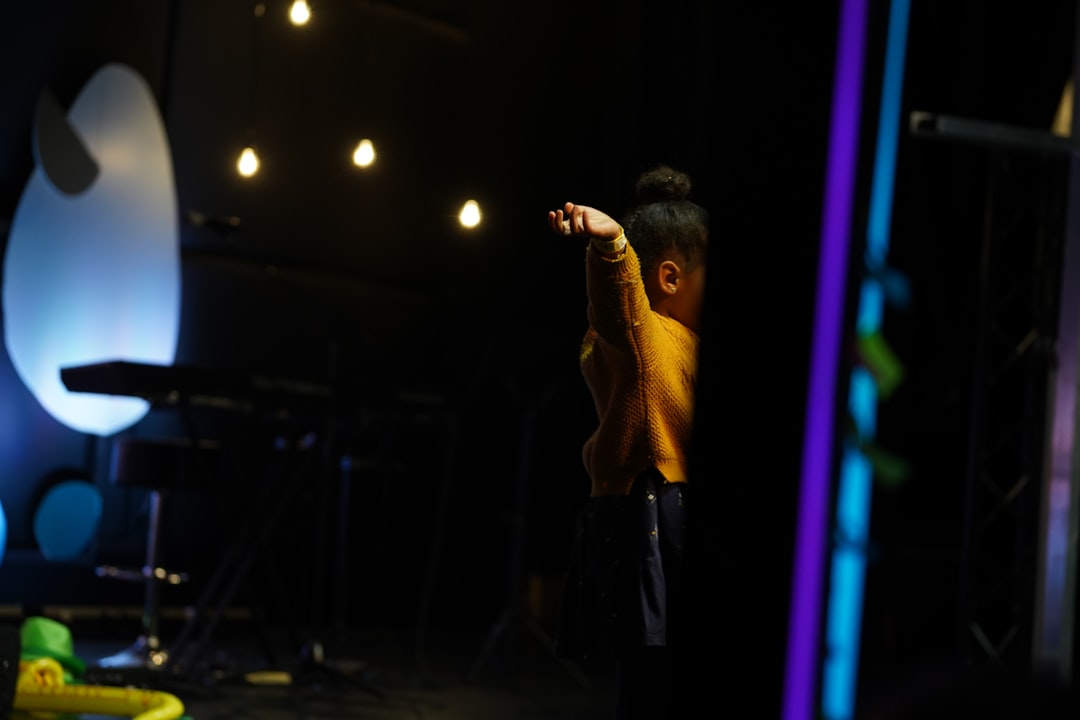 a person standing on a stage with a microphone