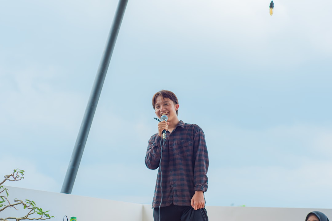 a man standing on a stage holding a microphone