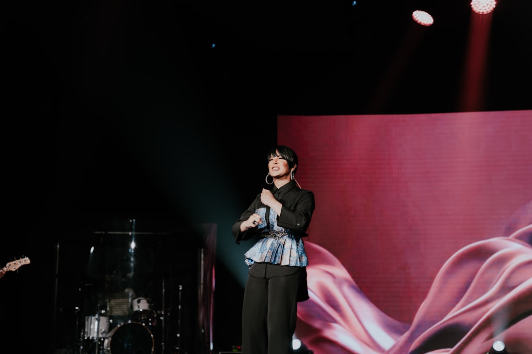 a man standing on a stage holding a microphone