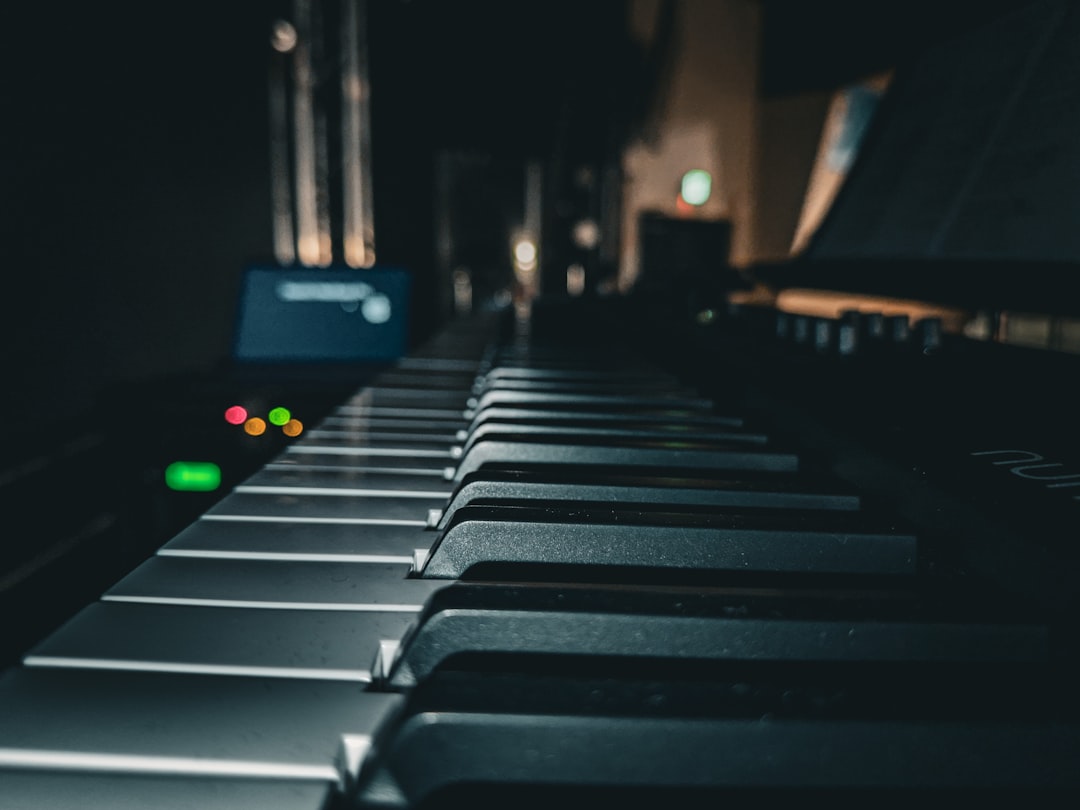 a close up of a piano keyboard in a dark room