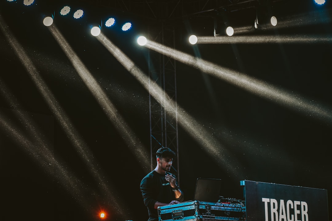 a man standing on top of a stage next to a keyboard